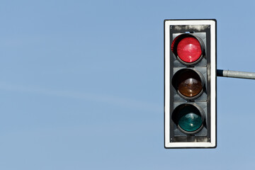 Stop red light on traffic lights. Isolated on blue background. Negative copy space.