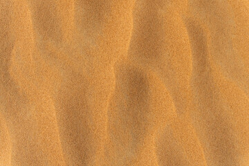 Sand summer smooth texture. Close up of sand wave dune background. Copy space for text. Top view.