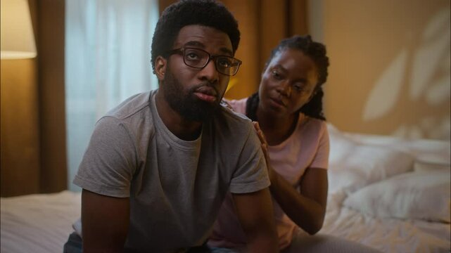 African American married family ethnic couple quarrel argument conflict guilty woman wife comforting calming ask for forgiveness annoyed man husband shaking head no never reject at home bedroom night