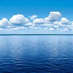 Obraz premium Serene Lake Landscape with Fluffy Clouds and Blue Sky