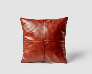 Stylish brown leather cushion resting on white background