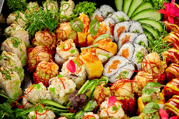 Sushi platter displaying variety of colorful rolls and ingredients © nazarovsergey