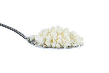 Fresh crumbly milk cottage cheese on a metal spoon against a white background.
