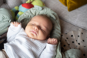 baby boy sleeping on sofa in cafe.