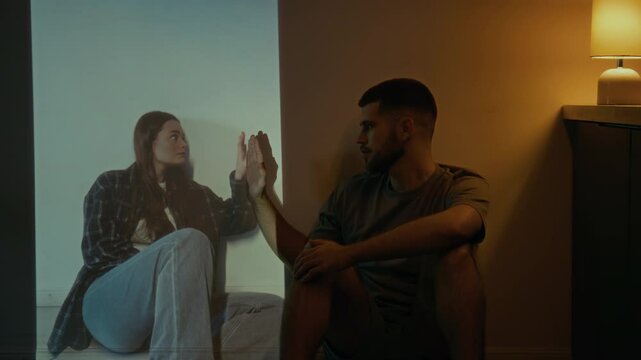 Full low key shot of young bearded widower missing his deceased wife, dreaming of seeing her smile and touching her hand once again, sorrow, grief and pain from parting