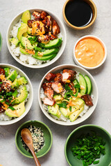 Spicy salmon roll bowls with vegetables and avocado.top veiw