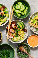 Spicy salmon roll bowls with vegetables and avocado.top veiw