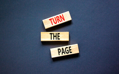 Turn the page symbol. Concept words Turn the page on beautiful wooden block. Beautiful black table...