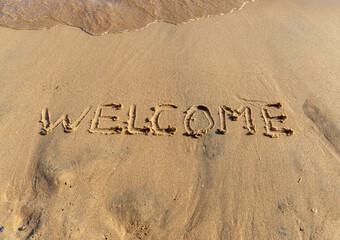 Business hello and welcome concept. Concept word Welcome written on beautiful Red sea ocean sand beach. Beautiful Red sea ocean sand beach background, copy space. Business hello and welcome concept.