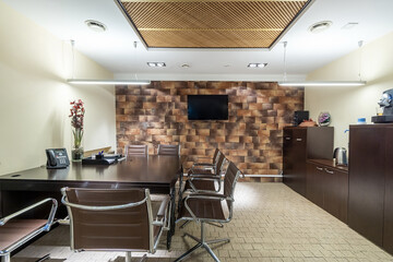 Modern interior of an office meeting room with a large table. Original wall and ceiling decor..