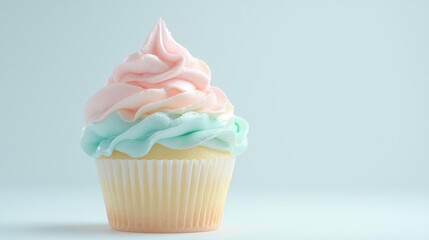 The image is of a cupcake with a light blue background. the cupcake has a white paper liner and is topped with a generous swirl of pink and light green frosting.