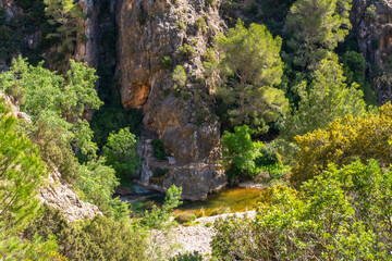 Canaletes river flowing at fontcalda sanctuary in gandesa, tarragona, spain
