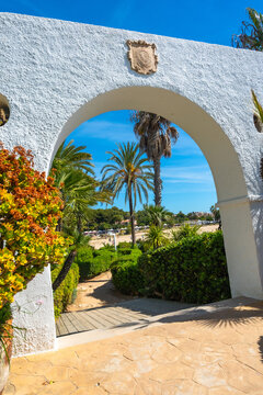 White archway leading to roc de sant gaieta beach in comarruga, spain