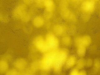 Natural abstract background with soft dappled sunlight and leaf shadows on a yellow plaster wall