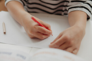 The boy draws with pens. Close up hands