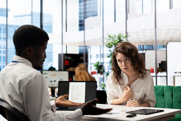 Woman feeling upset after not being selected by HR expert vetting applicants, ensuring their skills match role needs. Lady disappointed by headhunter not hiring her after assessing her work experience