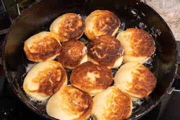 Golden-brown fried bread pieces sizzling in a cast iron skillet