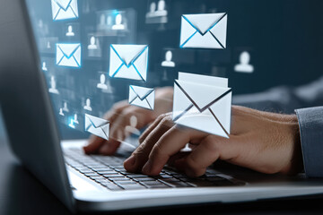 A person typing on an open laptop, with multiple icons of envelopes and people floating above the screen. 