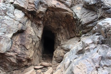 Gloomy Cave Entry in Rock Wall  
