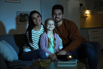 Family watching movie using video projector at home