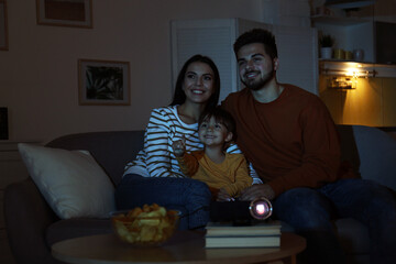 Family watching movie using video projector at home