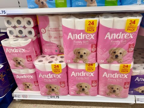 Essex, UK - March 21, 2025: Family packs of Andrex toilet roll stacked on a supermarket shelf for sale in the UK. 
