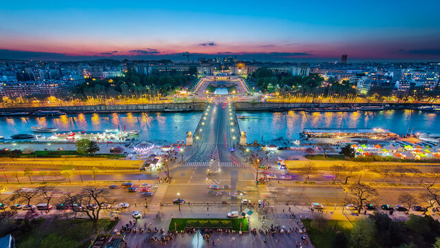 Aerial view of river Seine, Trocadero and La Defense from the Eiffel tower. Day to night timelapse. Paris, France, Europe. - Powered by Adobe