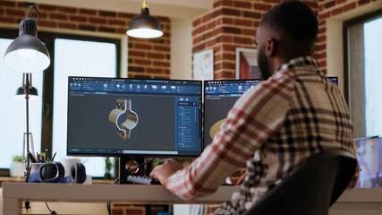 African american industrial designer works on prototypes in a creative studio. Doing tech driven...