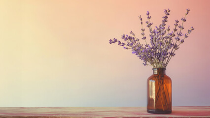 Glass bottle with lavender bouquet on wooden surface and pastel background. Aromatherapy theme.