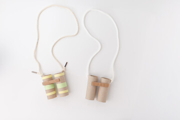 Recycled cardboard binoculars made from toilet paper rolls and string, ideal for eco education,...