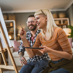 couple man and woman paint on canvas on easel at home leisure hobby