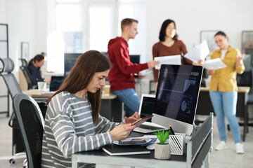 Stock exchange. Woman working at desk in office
