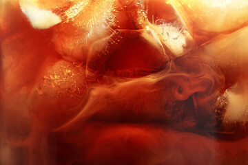Refreshing coffee with ice and milk as background, closeup