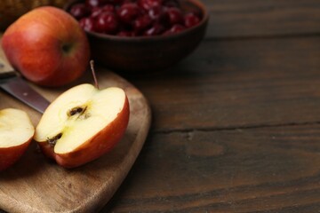 Apples and tasty cherries on wooden table, closeup. Space for text