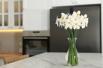 Beautiful daffodils in vase on white marble table indoors, space for text