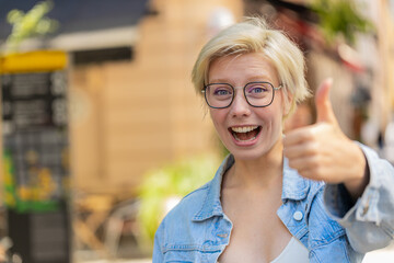 Like. Happy woman shows thumbs up agrees with something or gives positive reply recommends...