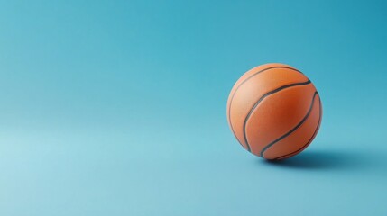 Fototapeta premium Orange Basketball on Blue Background: Minimalist Sport Photography