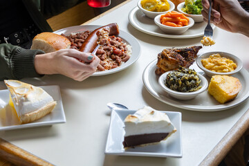 Southern food on table while people share a meal