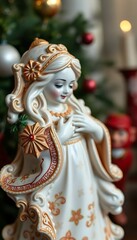 figurine of a woman with a christmas tree in the background