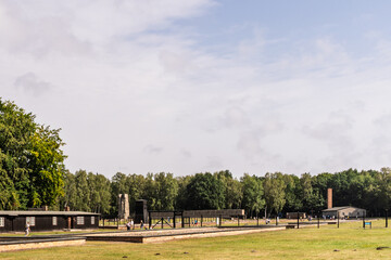 A large field with a few buildings in the background