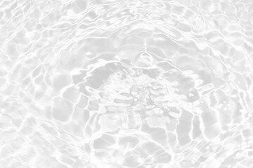 White water with ripples on the surface. Defocus blurred transparent white colored clear calm water surface texture with splashes and bubbles. Water waves with shining pattern texture background.
