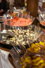 Colorful array of candies displayed in large containers at a festive market during the evening hours