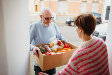 senior with delivery of fresh produce at doorstep of family home