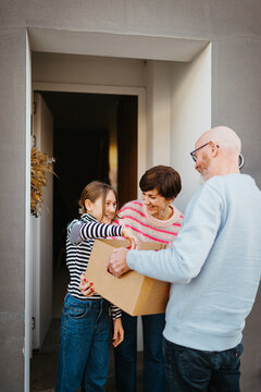 Family receiving food delivery at their doorstep