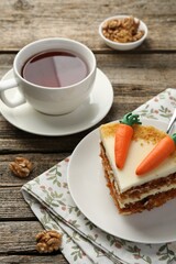 Piece of delicious homemade carrot cake served on wooden table