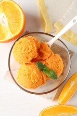 Tasty orange sorbet, fresh fruits and mint on white table, flat lay