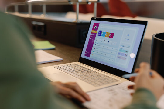 Open laptop of IT company developer working on interface of new app