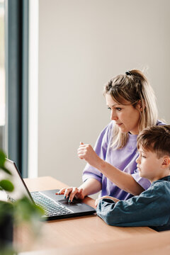Mother teaching son to shop online