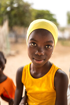 Young girl with yellow shirt and headscarf in Senegal, Africa