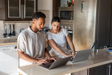 A couple working from their kitchen at home